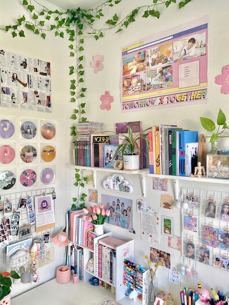 a desk with lots of books and pictures on the wall