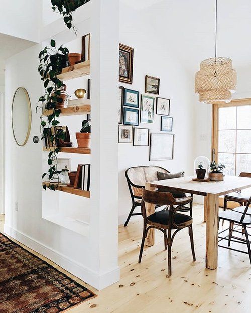 an instagram page with a table and chairs in the middle, some pictures on the wall