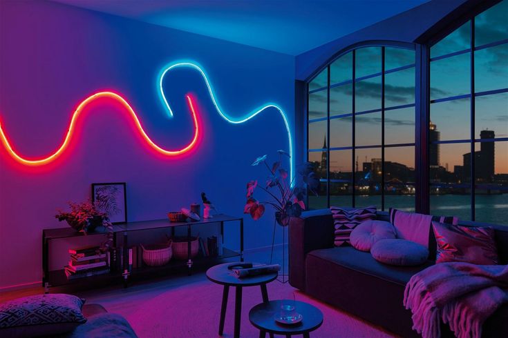 a living room filled with furniture and neon lights