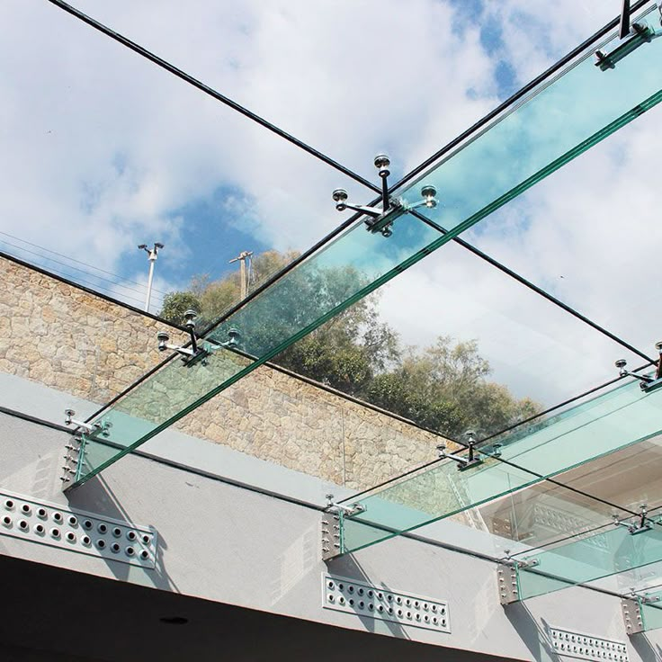 the sky is reflected in the glass on the building