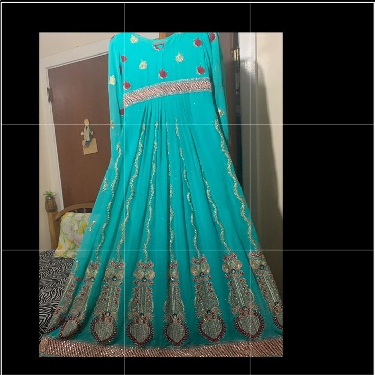 Heavily Embellished And Brand New. It Is A Small Size. It Includes A Dupatta And A Churidar Pajama. Plaited Back. Blue Floor-length Sequined Anarkali Set, Traditional Turquoise Dress For Festive Occasions, Traditional Turquoise Festive Dress, Semi-stitched Blue Sequined Anarkali Set, Designer Blue Salwar Kameez With Sequins, Designer Blue Sequined Salwar Kameez, Traditional Blue Salwar Kameez With Sequins, Blue Anarkali Salwar Kameez With Sequins, Fitted Embroidered Blue Anarkali Set