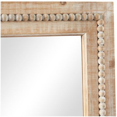 a mirror that is made out of wood and has shells on the edge of it