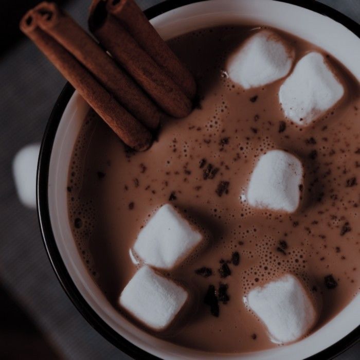 a cup filled with hot chocolate and marshmallows