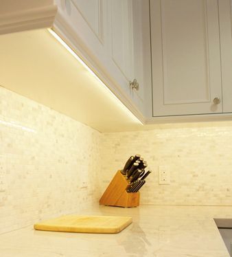 a kitchen counter with knives and cutting board on it