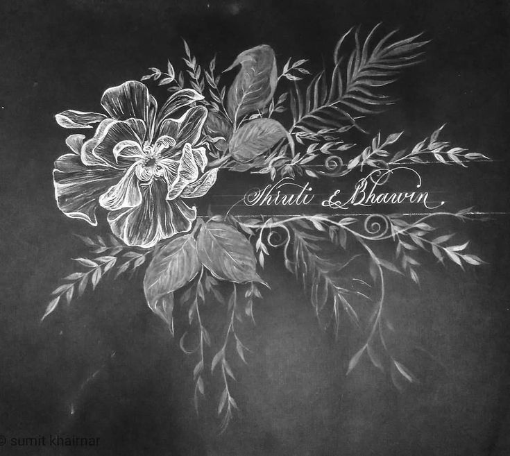 a chalk drawing of flowers and leaves on a blackboard