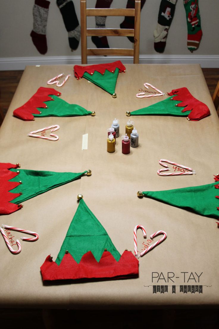 the table is decorated with christmas stockings and candy canes