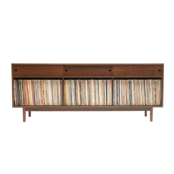 an entertainment center with several records on the front and side shelves, all in different colors