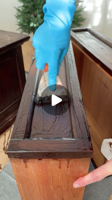 a person in blue gloves cleaning a wooden table