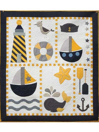 a quilted wall hanging with boats, anchors and other things on it's side