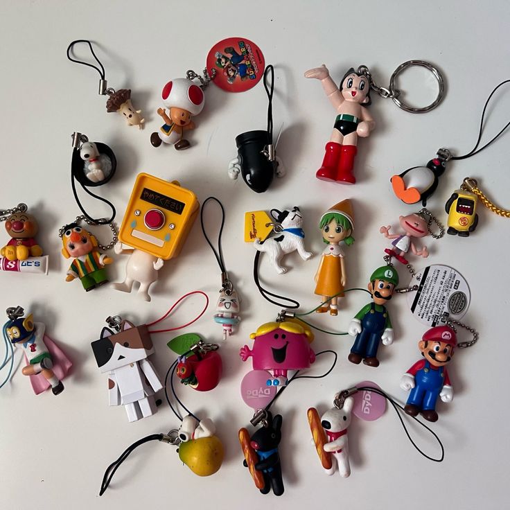 many different key chains are arranged in the shape of a circle on a white surface