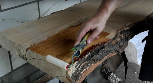 a person is using a knife to cut wood