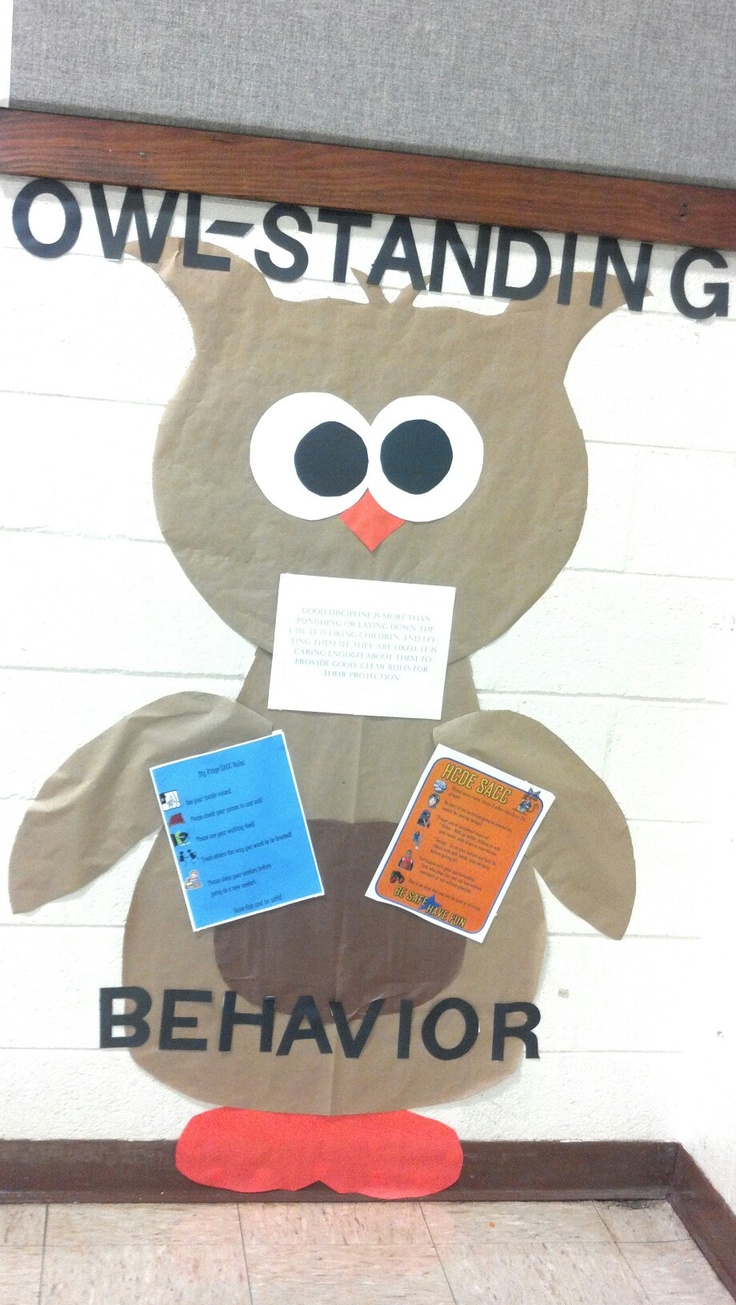 a bulletin board with an owl standing on it's hind legs and holding papers