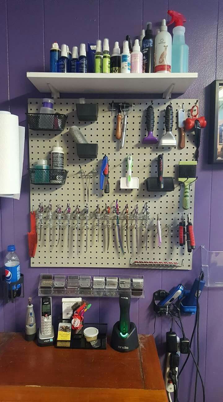 there is a pegboard with many different items on it in the room that has purple walls