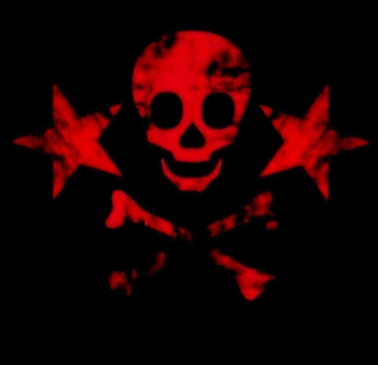 a creepy clown with three red stars on his face in the middle of a black background