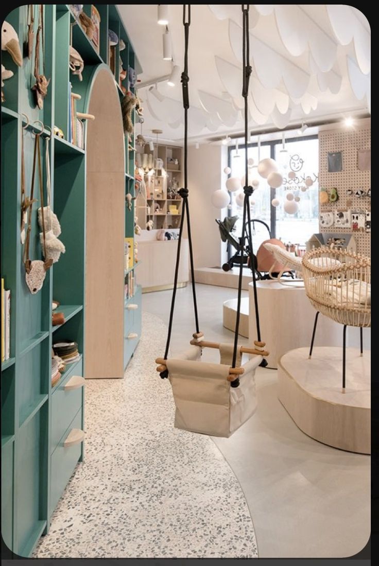 the interior of a store with swings and shelves