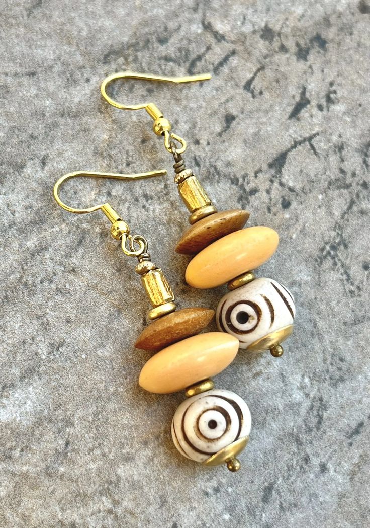 Tribal Boho Earrings African Batik Bone and Brass Beads Bohemian Cream Jewelry With Wooden Beads, Bohemian Cream Jewelry With Ear Wire, Bohemian Beige Jewelry With Dangling Beads, Bohemian Cream Beaded Earrings With Dangling Beads, Bohemian Gold Beaded Earrings With Wooden Beads, Bohemian Brass Jewelry With Gold Beads, Handmade Beige Beaded Bohemian Earrings, Bohemian Earrings With Wooden Beads, Bohemian Cream Beaded Dangle Earrings