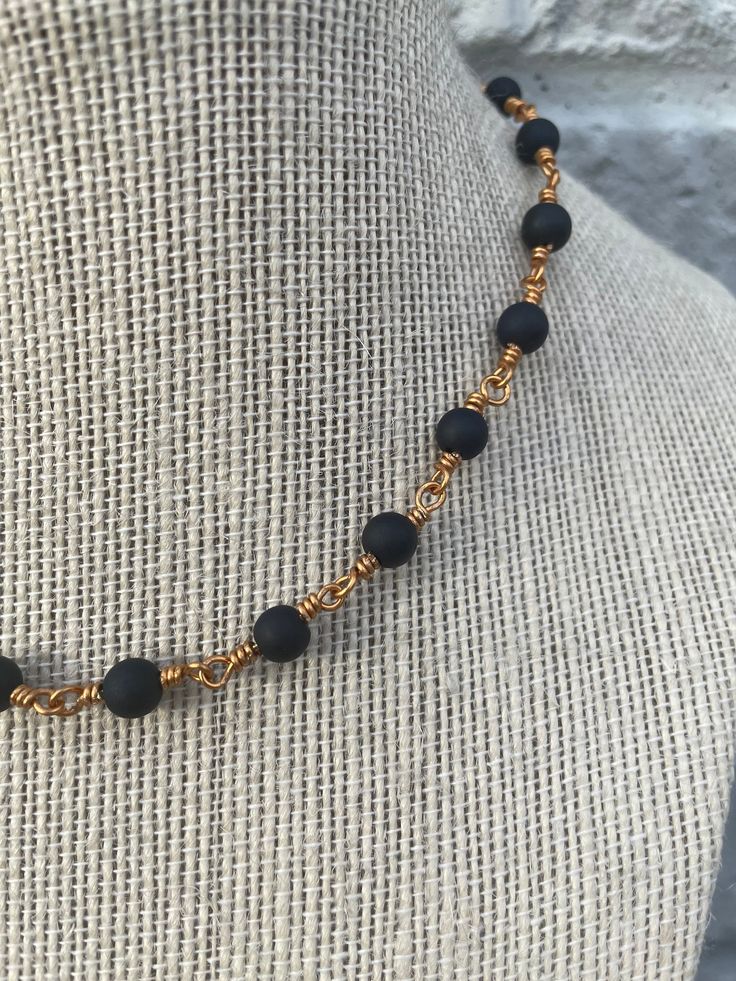 This 16 inch choker features 6mm black sea glass beads, wire wrapped in gold. Since black and gold both match anything, this necklace can be worn with just about anything. If you love this look but would prefer the necklace be longer, please message me! I would be happy to add length before you buy.  Instagram: buoyantbeads_ Adjustable Black Wire Wrapped Beaded Necklaces, Adjustable Black Wire Wrapped Beaded Necklace, Black Wire Wrapped Choker Jewelry, Adjustable Gold Wire Wrapped Beaded Necklaces, Minimalist Black Wire Wrapped Necklace, Sea Glass Beads, Gold Choker, Black Sea, Chain Styles