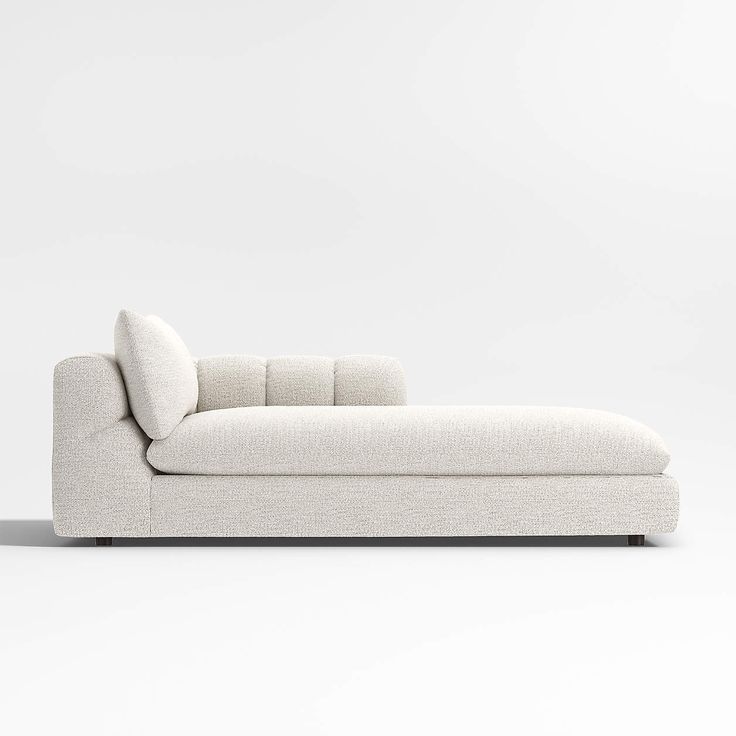 a white couch sitting on top of a white floor