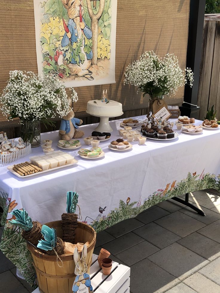 a table that has some food on it and flowers in the vases next to it