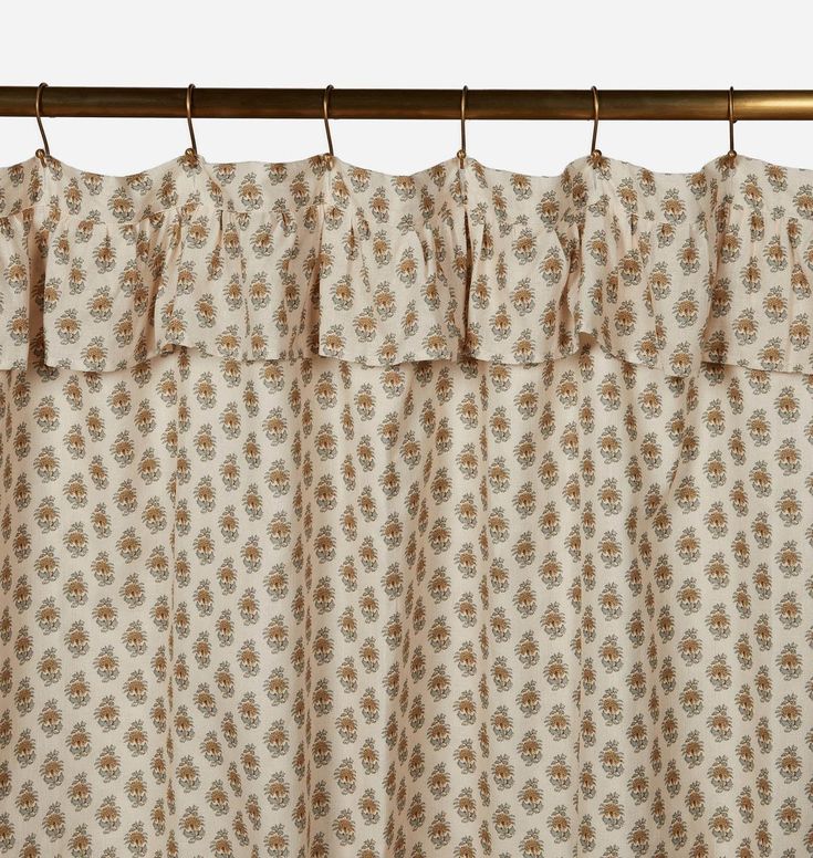 a curtain with ruffled edges hanging on a rod