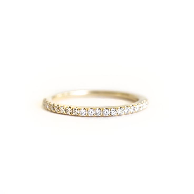 a yellow gold wedding band with white diamonds