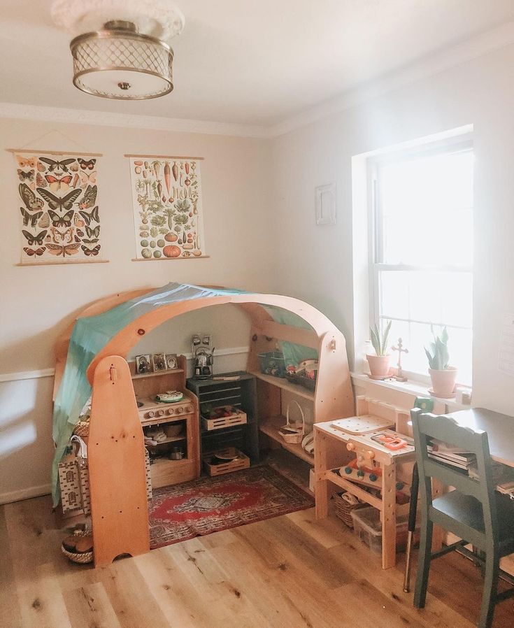 a child's room with a bed, desk and chairs