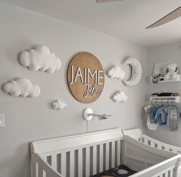 a baby's room decorated in gray and white