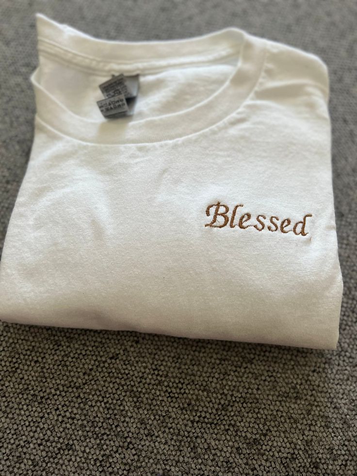 Choose any short quote and I can embroider it for you on a t-shirt! Different color letters and t-shirts available! I have any color thread and the t-shirt colors are as listed thank you :) (100% cotton) Text Embroidery Shirt, Cotton T-shirt With Embroidered Text, Crew Neck, White Cotton T-shirt As Gift, White Cotton T-shirt With Custom Embroidery, White Cotton T-shirt With Embroidered Graphics, White T-shirt With Letter Embroidery As Gift, Basic Cotton T-shirt With Embroidered Logo, Graphic Tee With Letter Embroidery Crew Neck, Graphic Tee With Letter Embroidery