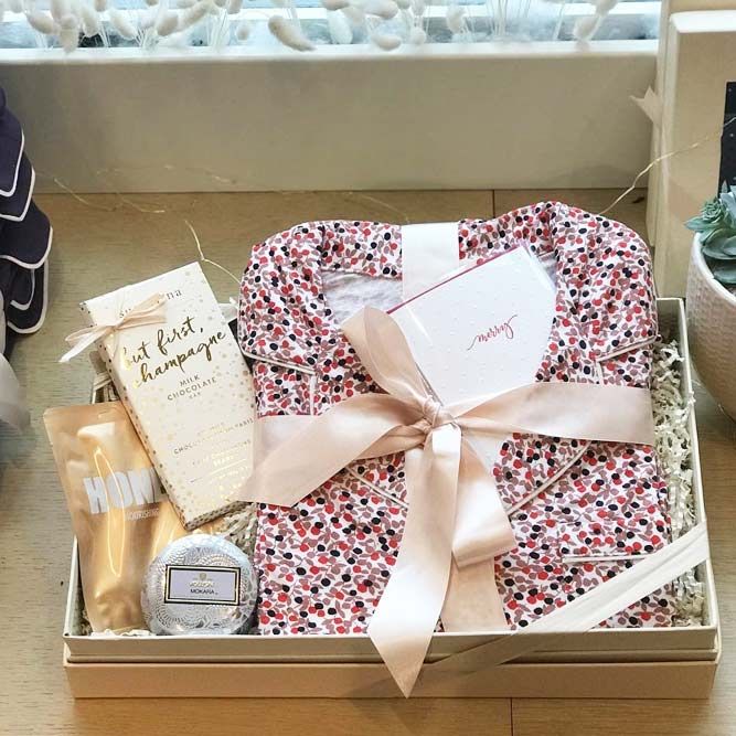 an open box with various items in it sitting on a table next to a potted plant