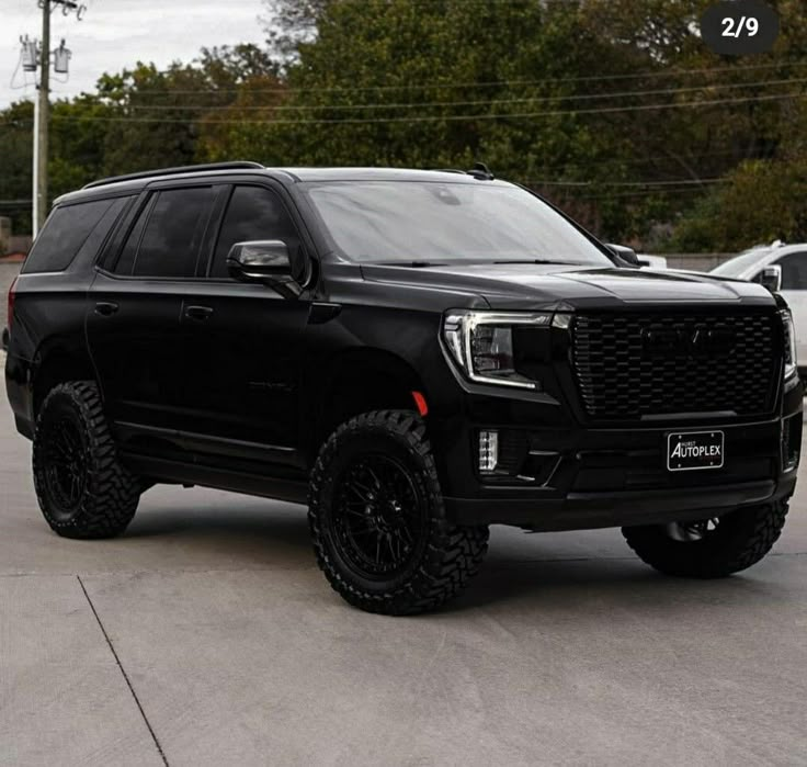 a large black truck parked in a parking lot