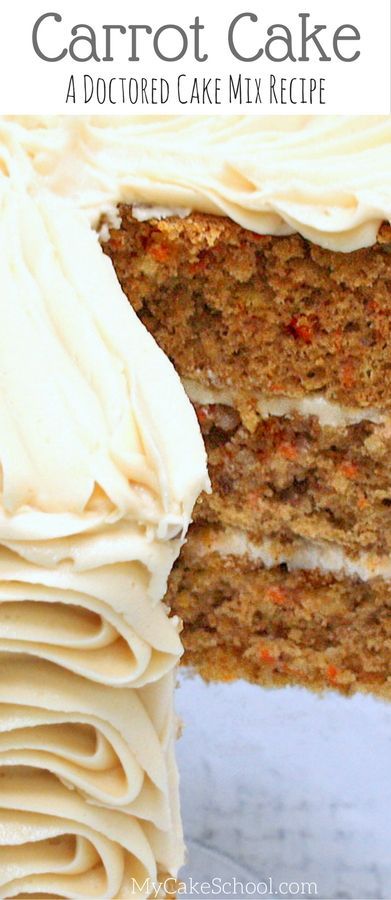 a carrot cake with white frosting on top is cut in half to show the layers