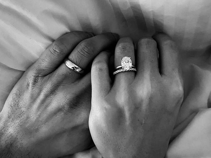 two hands holding each other with wedding rings on their fingers