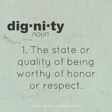 a white sign with the words dignity now written in black ink on it