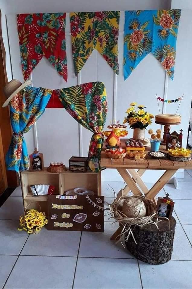 a table topped with lots of food on top of a white tiled floor next to a wall