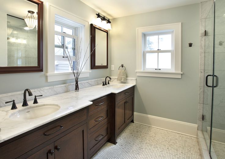 a bathroom with two sinks and a shower