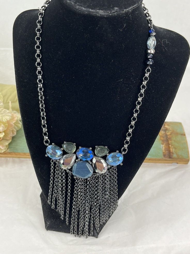 Add a bohemian touch to your outfit with this Chico's Panel Blue Glass Necklace. The necklace features a unique panel style with blue glass beads and an unknown metal base. Perfect for any occasion, this necklace is sure to add a pop of color to your look. The necklace measures [insert measurements here] and is ideal for those who love to add a little bit of flair to their wardrobe. Get ready to turn heads with this trendy and stylish necklace! Blue Bohemian Necklaces For Party, Blue Beaded Chain Necklace For Party, Blue Beaded Necklaces With Chain, Blue Long Necklace For Party, Turquoise Glass Necklaces For Party, Blue Glass Beaded Necklaces For Party, Turquoise Glass Necklace For Party, Blue Metal Crystal Necklaces For Jewelry Making, Blue Bohemian Crystal Necklaces For Party