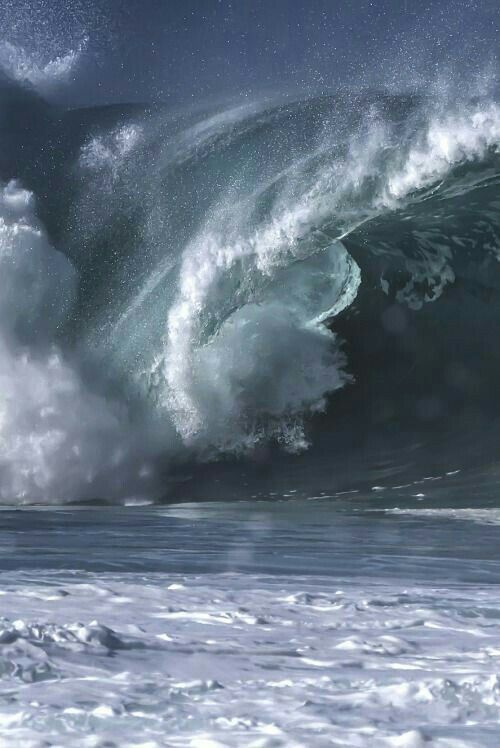 a large wave is crashing into the ocean