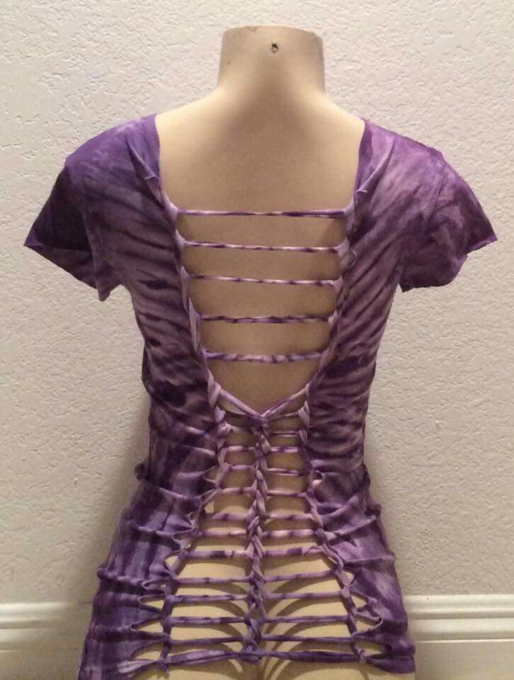 a mannequin wearing a purple dress with cut outs