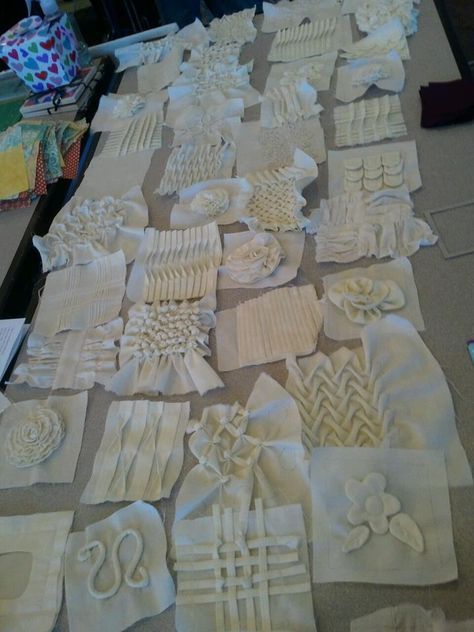 many pieces of white fabric are laid out on the floor and ready to be sewn