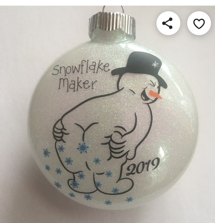 a white ornament with a snowflake maker on it's face