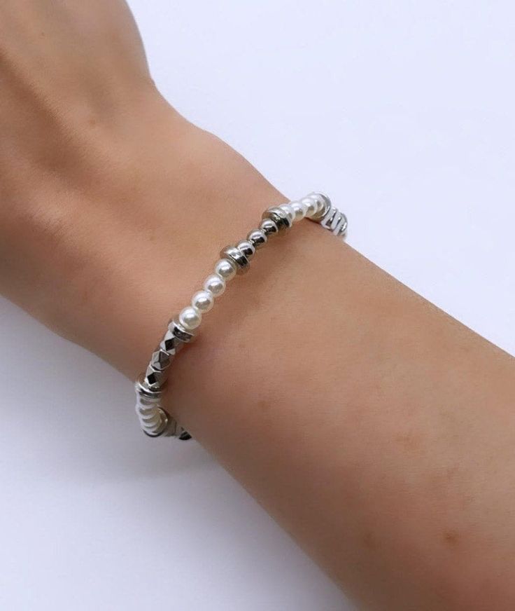 NEW from the Wool + Pepper Co. Fall 2021 Collection! (1) Elegantly Crafted Silver & Pearl Beaded Bracelet. One size fits all - stretch material used.  Designed by Wool + Pepper Co.  Follow us on Instagram: @woolandpepperco Silver Beaded Metal Pearl Bracelet, Silver Beaded Pearl Stretch Bracelet, Silver Pearl Stretch Bracelet As Gift, Silver Pearl Stretch Bracelet, Silver Pearl Stretch Bracelet Gift, Silver Pearl Stretch Bracelet For Gift, Silver Pearl Bracelet, Hand-strung, Silver Beaded Pearl Bangle Bracelet, Glass Heels