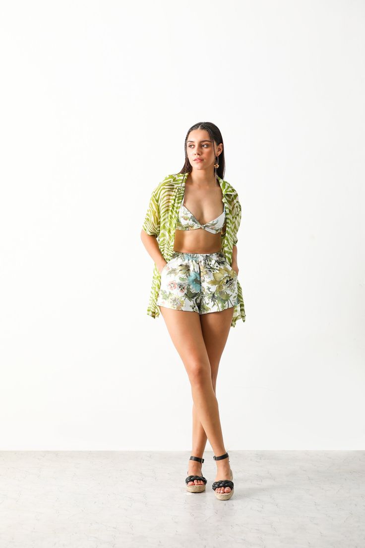 Product Name: RIONA CO-ORD (BRALETTE & SHORTS)Product Description:The Iaso riona set crafted in cotton polyester satin fabric featuring a bralette & shorts.A perfect set for a beach day.Size and Fit: Fits true to size Intended for a Relaxed fit Bralette neckline at 12" Elasticated at the back & shoulder tie up for adjustable fit Non stretchy fabric Pull on shorts with elasticated waist Model is 175cm/ 5'8" and is wearing small size Shorts length is 14" Bralette length is 13" Details and Care: COLOR:White COMPOSITION:Cotton & Polyester mix CARE: Dry clean only PLACE OF ORIGIN: India DELIVERY TIME: 12-14 Working Days