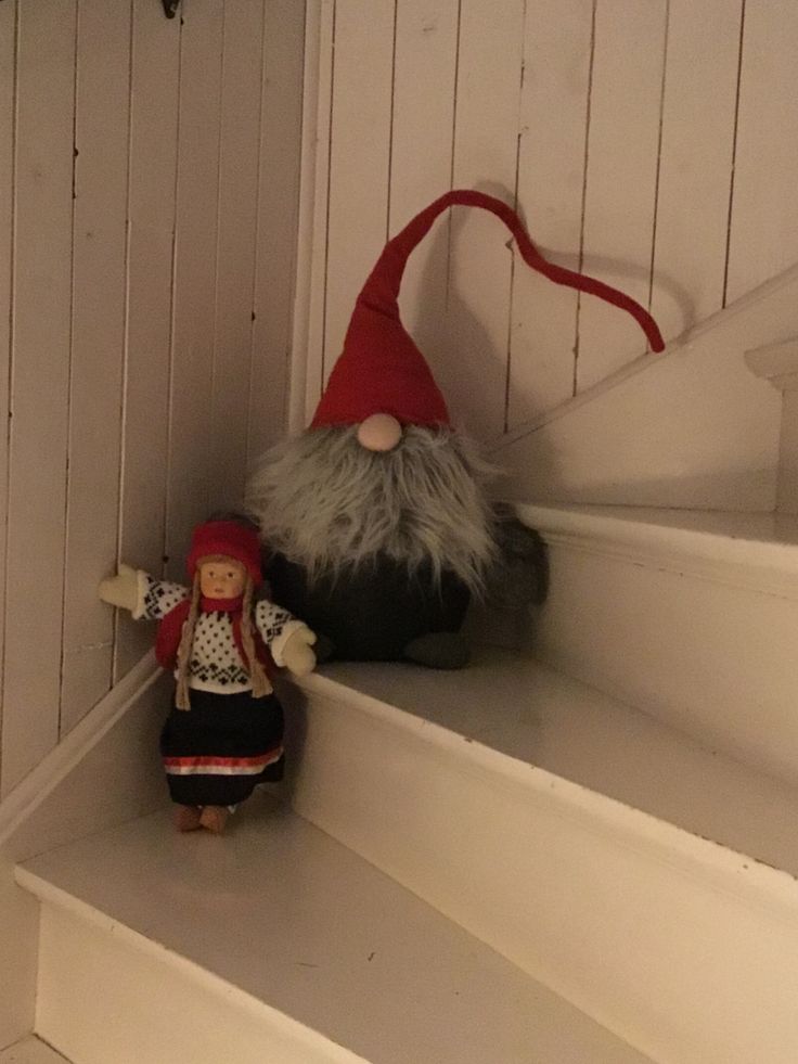 a gnome doll sitting on top of a set of stairs