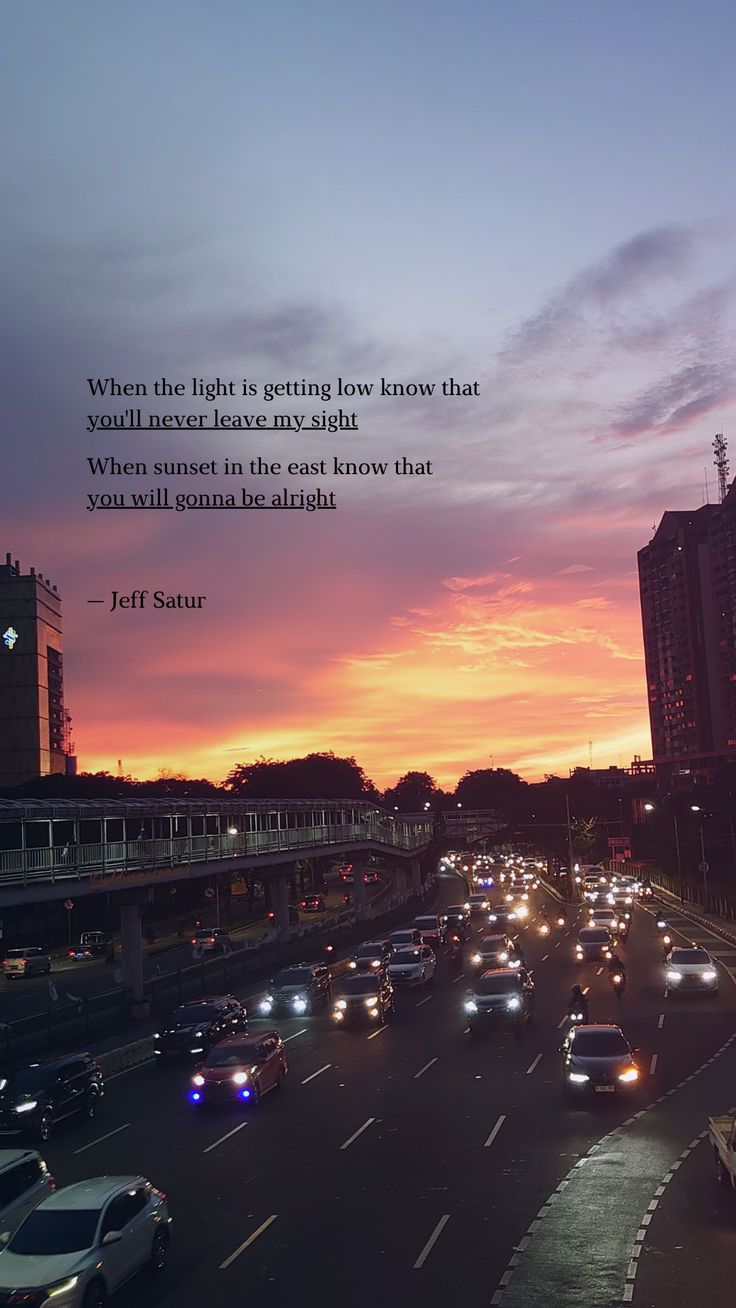 a city street filled with lots of traffic under a colorful sky at sunset or dawn