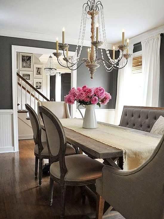 a dining room table with chairs and a chandelier