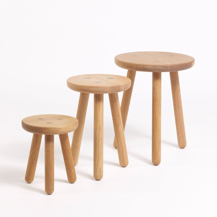 three wooden stools sitting next to each other