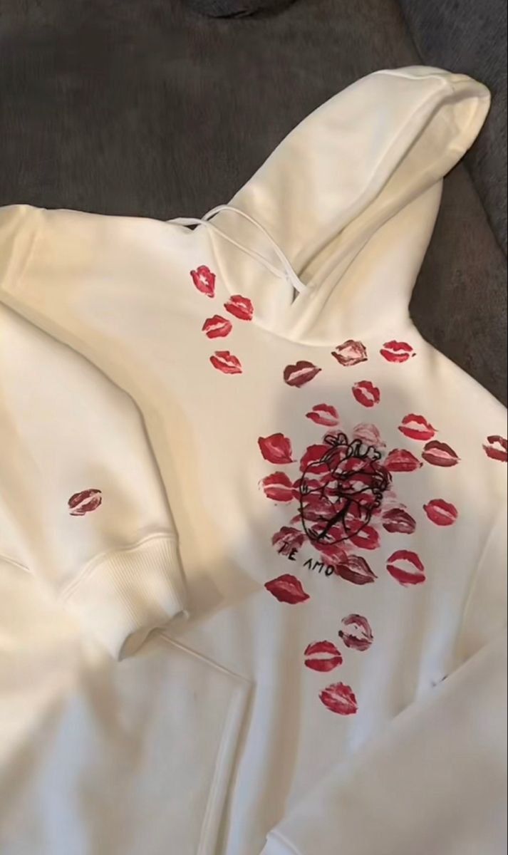 a white hoodie with red lips on it