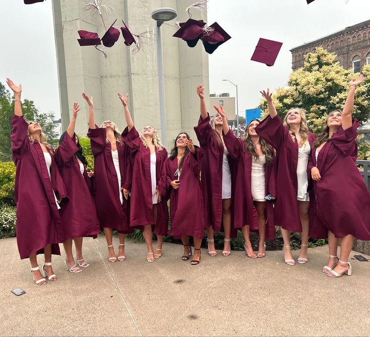 a group of graduates throwing their caps in the air