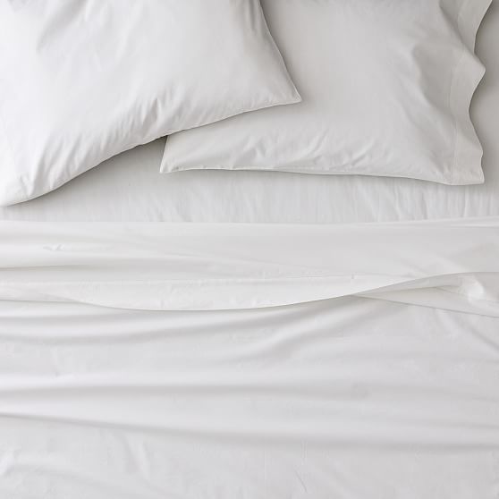 white sheets and pillows are on top of each other in this bedding set that is made up