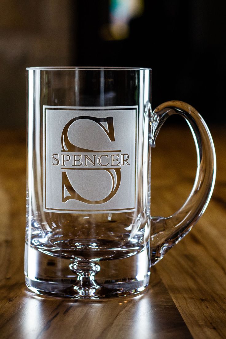 a glass mug with the word spencer on it